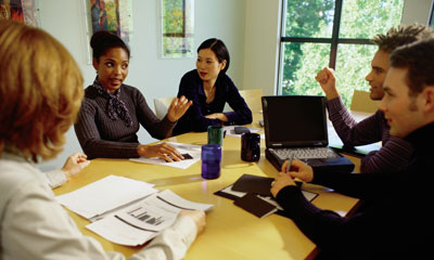 Marketers sitting around a table discussing